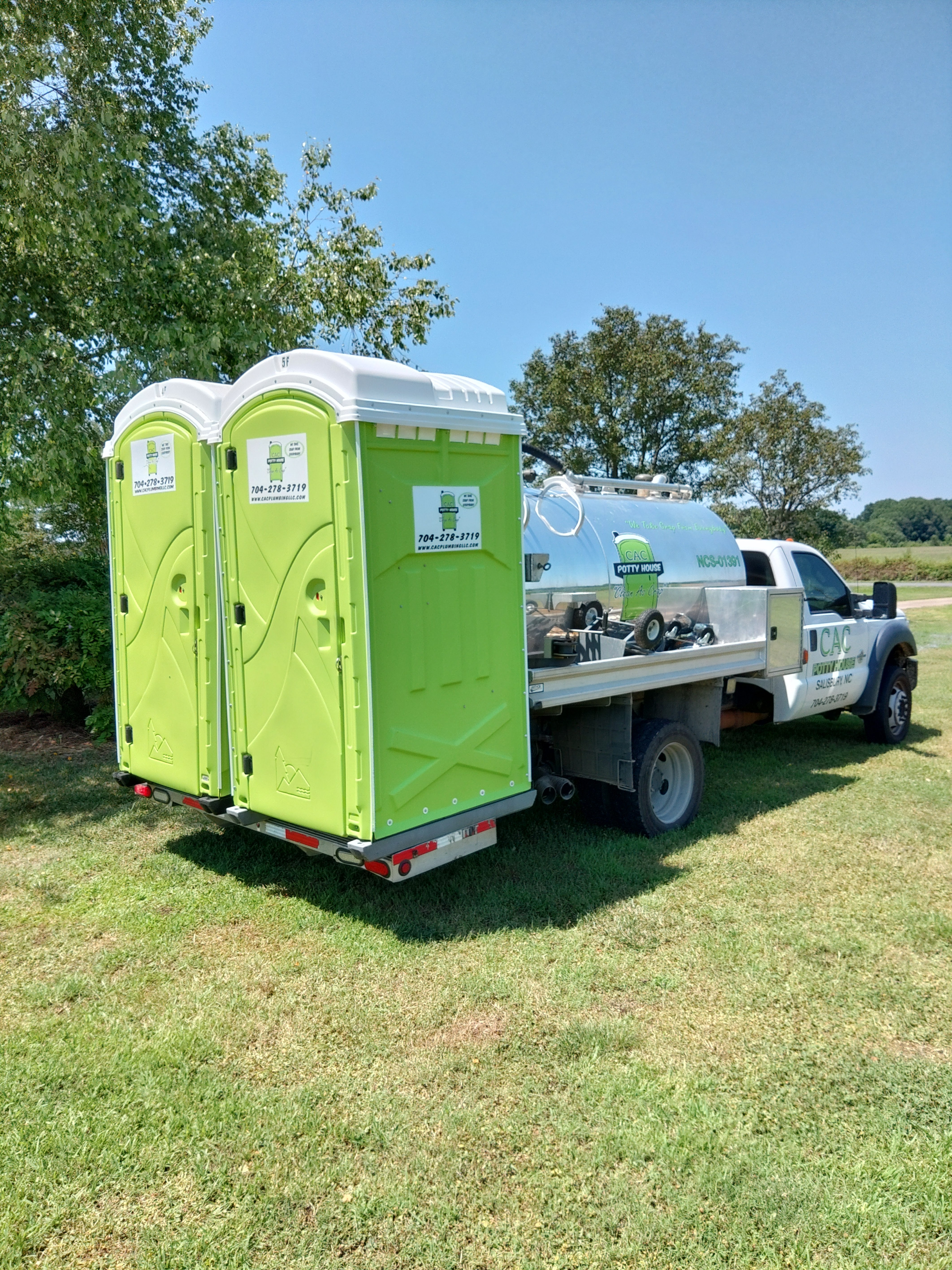 two portable toilets and a pump truck