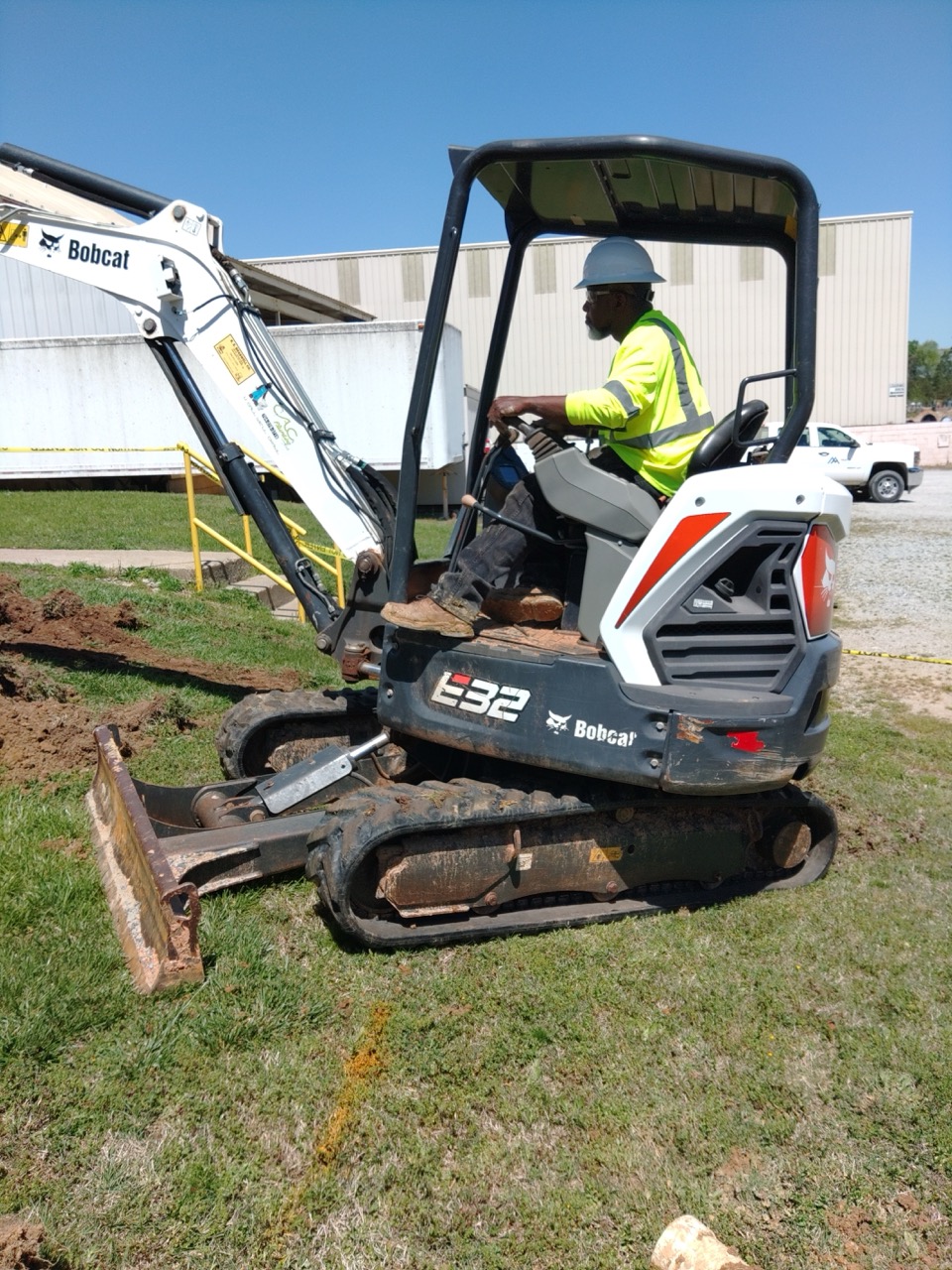 large equipment being used to dig a trench for plumbing pipes